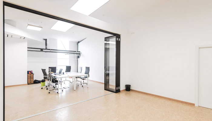 Glazed sliding movable office wall